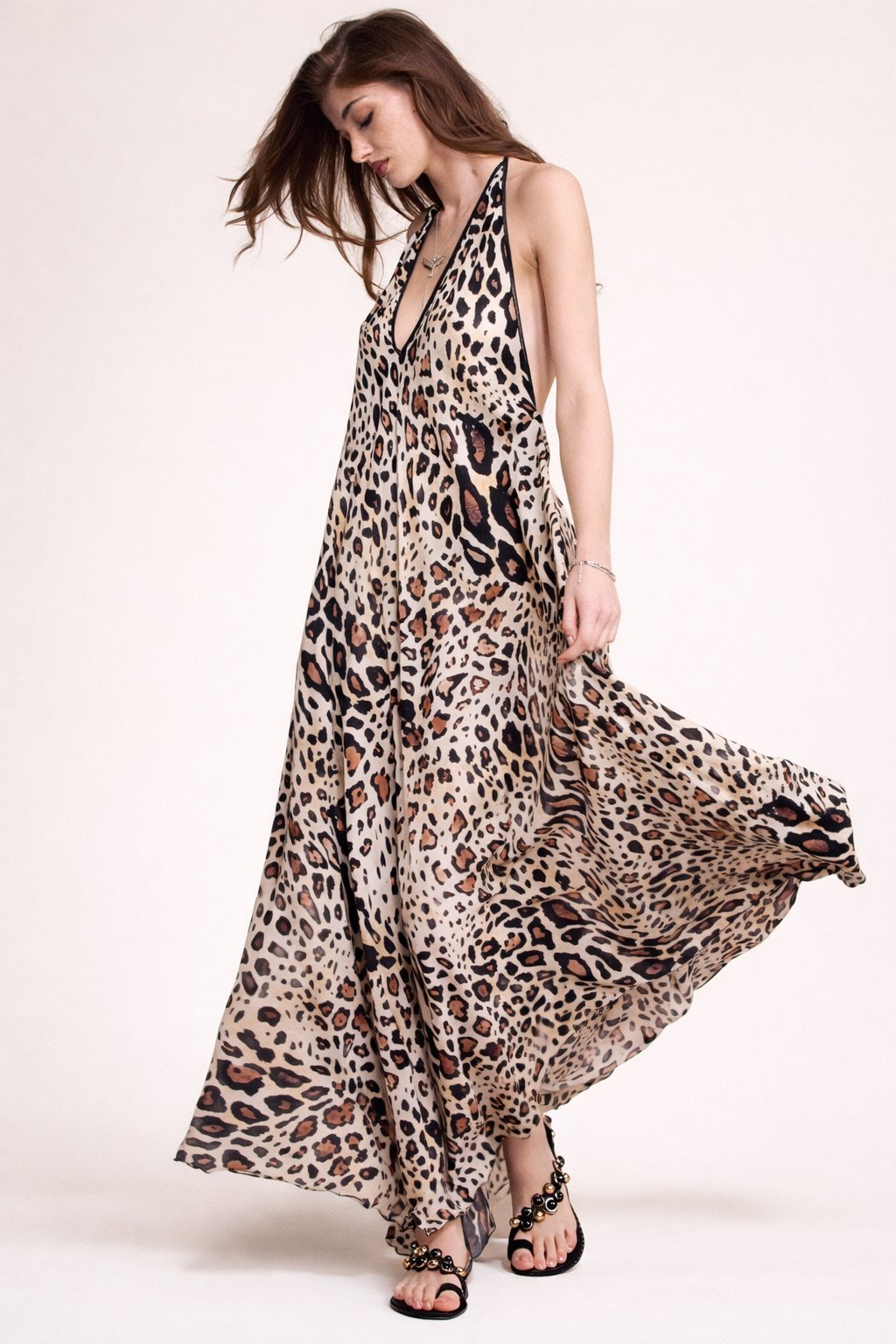 Woman wearing a leopard print dress on a white background