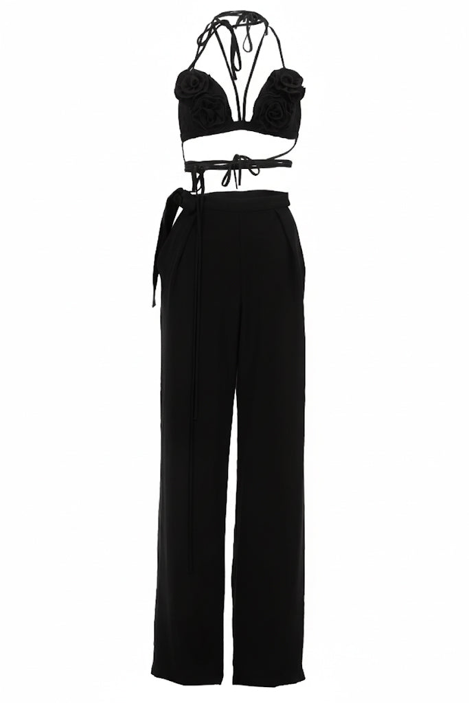 Black two-piece outfit with a top and wide-leg pants on a white background